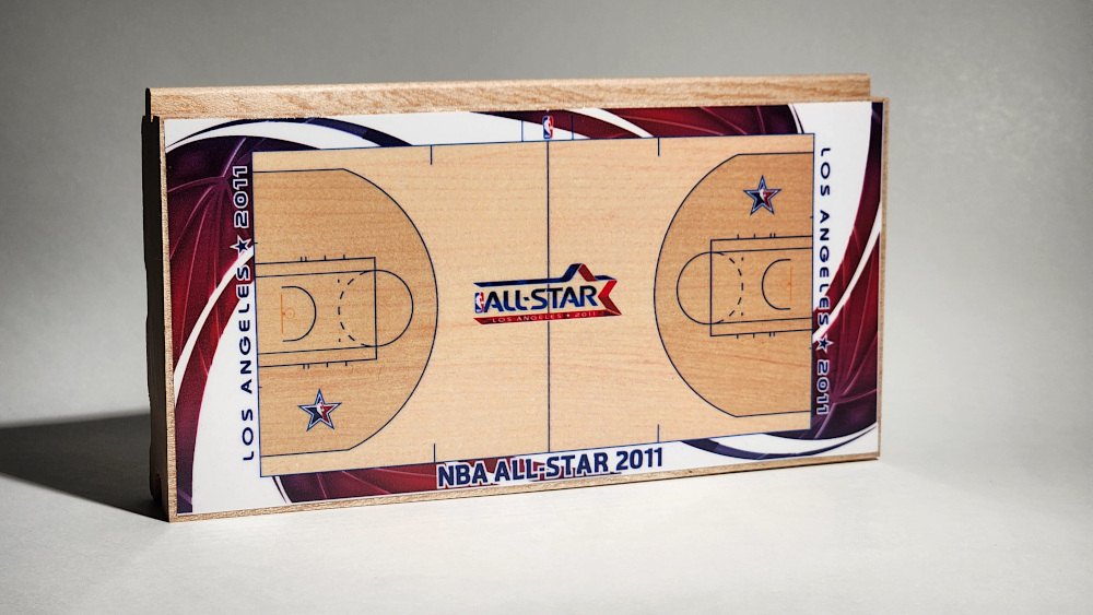 A replica of the Los Angeles 2011 NBA All-Star basketball floor shown on a piece of hardwood flooring by Horner Sports Flooring