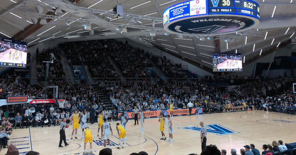 Warranty Page - image of the Villanova University basketball court taken from the stands with center scoreboard shown above and the arena stands in the background