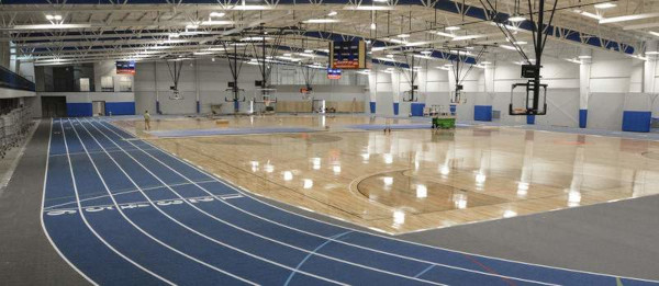 hardwood basketball court practice facility with indoor synthetic track