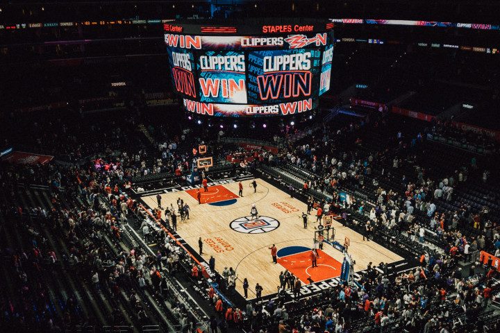 Wide image from above showing LA clippers basketball court, staples center arena, and scoreboard used to highlight floors on the decision maker page.